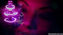 Samantha Saint explores intense lesbian pleasures under the glow of black light, showcasing her big tits and ass.