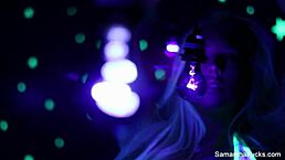 Samantha Saint explores intense lesbian pleasures under the glow of black light, showcasing her big tits and ass.
