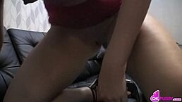 brunette cutie masturbates on the couch, fingering her shaved pussy to orgasm