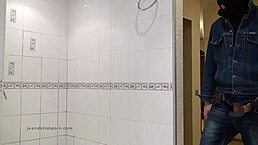 der master in blue jeans washes up barefoot in the bathroom with wet style