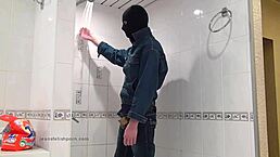 der master in blue jeans washes up barefoot in the bathroom with wet style