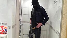 der master in blue jeans washes up barefoot in the bathroom with wet style