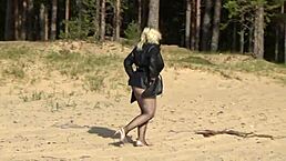 hot milf struts in mesh suit on beach.