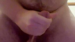 A guy masturbates solo in a casual setting.