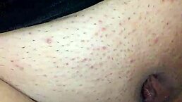 feeling intense pleasure with a black dildo while bound