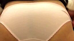 Shemale in toilet inserting tampon and napkin.