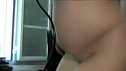 the pregnant camgirl uses a creamy dildo for fingering action on webcam