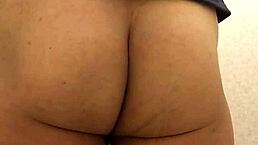 Shemale in toilet inserting tampon and napkin.