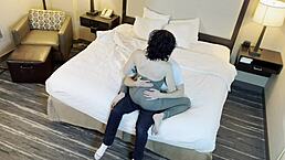 A beautiful petite 18+ girl with tattoos shares a gentle kiss in a romantic setting.