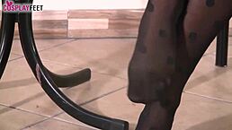 blonde ballerina teases with feet in dotted stockings.