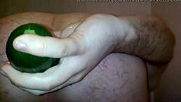 Gay guy inserts vegetable into ass in shower with cock