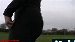 Mature milf strolls in park leggings