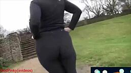 Mature milf strolls in park leggings