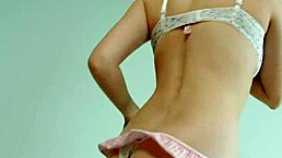 Cute Brunette Strips in Jeans and Touches Herself on Bed.