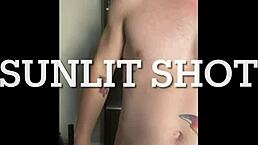 Twink strokes his huge cock under the warm sunlight