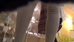 asian chick in big boots gets peed on by voyeur outdoors.