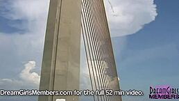 Topless brunette drives her convertible over the skyway bridge, flashing big tits to passersby