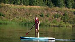 Skinny babe in pink micro bikini flashing outdoors in garden