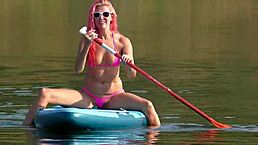 Skinny babe in pink micro bikini flashing outdoors in garden