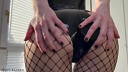 Latex tease in fishnets and boots, she whispers
