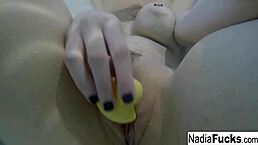sexy blonde nadia enjoys a bath with rubber duckies, showing off her tits and ass