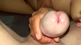 In this amateur scene, she gives a handjob leading to cum on big natural tits