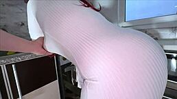 Mature woman in a sheer dress reveals her big ass in a thong.