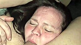 Milf sucks cock while playing with her tits in deep throat.