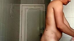 Why is this hot guy drinking while shaving his massive cock?