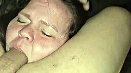 Milf sucks cock while playing with her tits in deep throat.