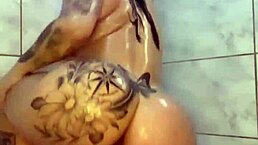 She dances, then plays with her ass in the shower.