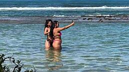 two brazilian girls kiss and play with big asses on the beach