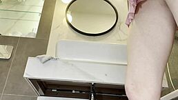 Braless hot brunette skinny and horny babe in a pink mini skirt to show her beautiful ass and legs in the bathroom