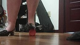 in this fetish scene, a woman crushes a cock under her high heels