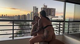 Latina in lingerie bent over for doggystyle anal with tattooed ebony babe riding cowgirl