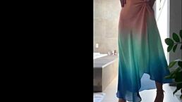 This mature Brazilian milf dances sensually outdoors in her short skirt and panties showing off big ass and small tits