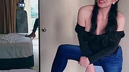 Hey, check out this pretty Asian ladyboy doing a jeans striptease with those big boobs.