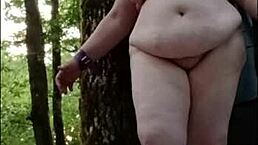 Slave Titia la Tertius gets chained in the forest for outdoor bondage and maledom humiliation with spanking and vibrator