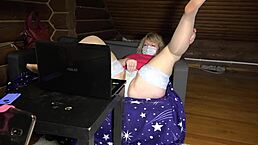 A blonde mature housewife teases her friend in sex chat, showing chubby figure, legs in stockings, big ass under skirt, and panties for homemade fetish fun.