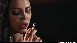 hot brunette with red lipstick nails and sexy lingerie touching herself while smoking cigarette