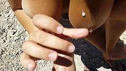 Thick babe flashes big tits on public beach. She gives outdoor blowjob with curvy body exposed.