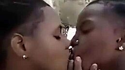 two liberian lesbos are making out and kissing in an uncompleted building outdoors