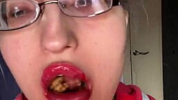 Giantess with big lips and eyeglasses eating Snickers protein bar
