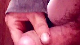 In a quiet homemade setting, an amateur explores solo pleasure with a focused handjob on his short foreskin.