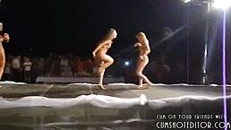 Women partying naked on stage with big tits and stripping at outdoor beach event 😎