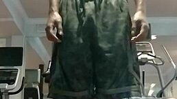 21-year-old athletic black woman with brown eyes works out in gym dorm