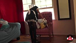 french maid in costume vacuums the house while handling cleaning tasks around the rooms