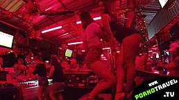 An Asian girl dances at a Thai bar with friends