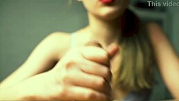 a beauty with red lips gives her boyfriend a close-up handjob until he reaches intense pleasure