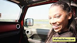 Ebony girl rubs wet clit in car while showing big natural boobs